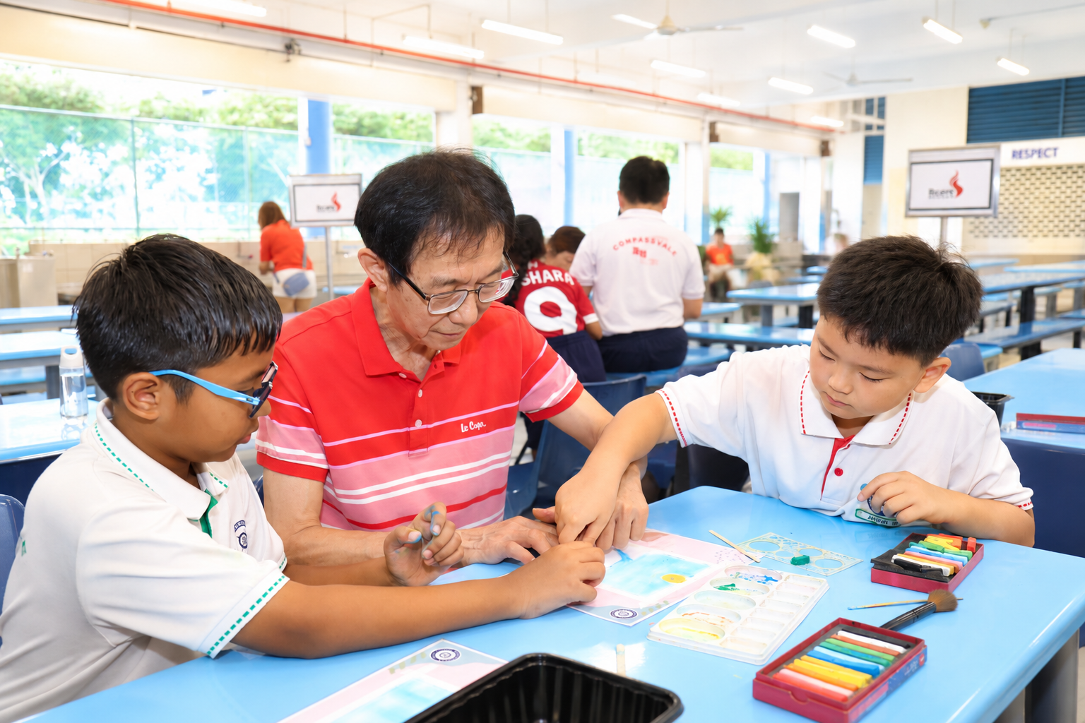 students and elderly working on an art work.